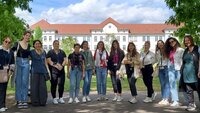 Studentinnen und Professorinnen stehen in einer Reihe vor einem Gebäude des Campus Aschaffenburg