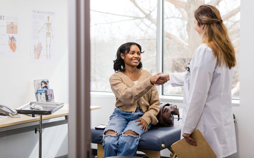 Eine Patientin wird von einer Ärztin behandelt.